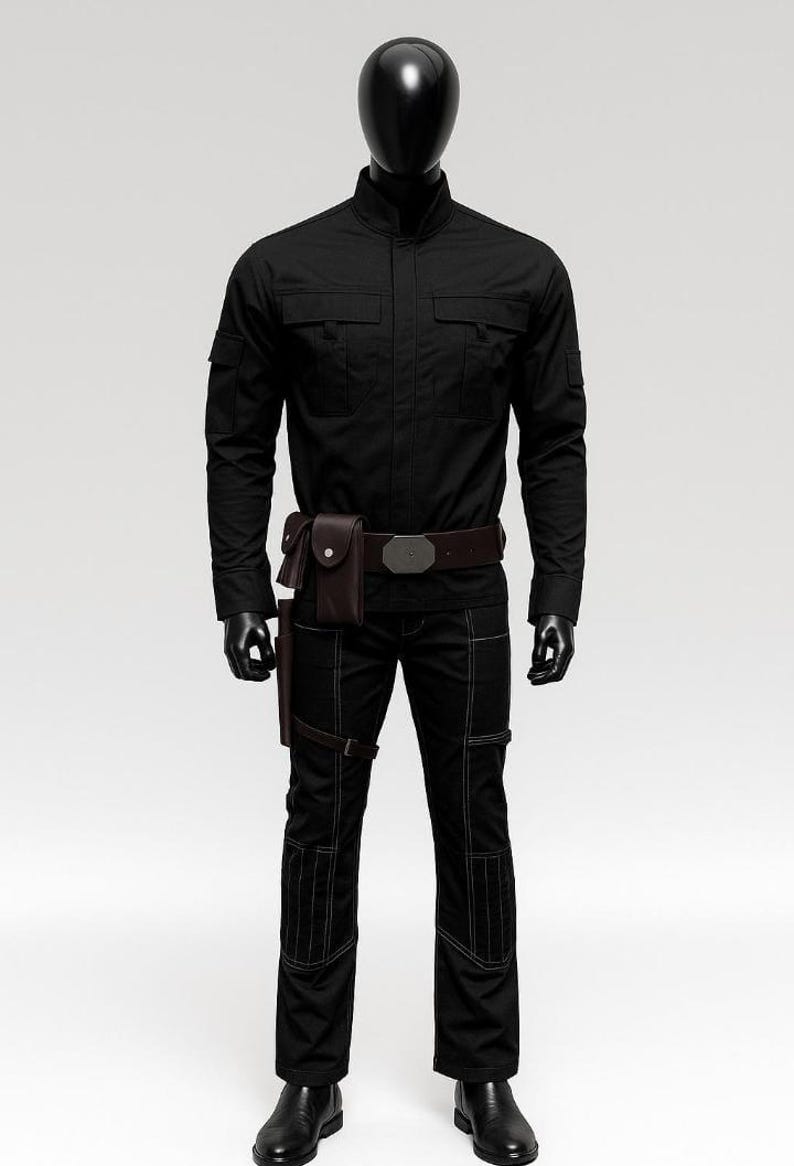 May include: Black tactical outfit on a mannequin. The outfit includes a long-sleeved shirt with two chest pockets, matching pants with reinforced stitching, a brown belt with a silver buckle, and a brown holster. The mannequin wears black gloves and shoes.