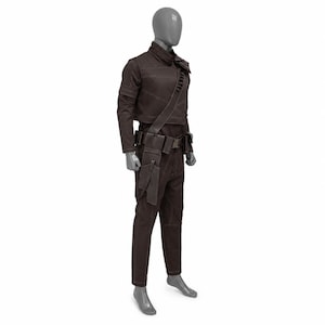 May include: A brown costume displayed on a mannequin. The outfit includes a jacket, pants, belt with pouches, and a shoulder strap. The jacket has long sleeves and a high collar. The pants are straight-legged. The costume is made of a dark brown material.