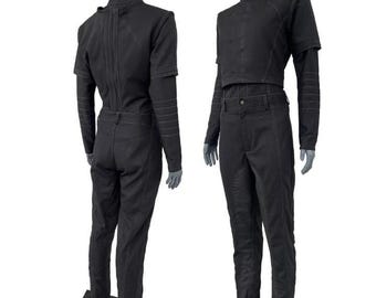 May include: Two-piece black outfit on a mannequin. The top is a short-sleeved, high-collared jacket with a cropped waist. The pants are high-waisted with a straight leg. The outfit has visible stitching details and is made of a dark fabric.