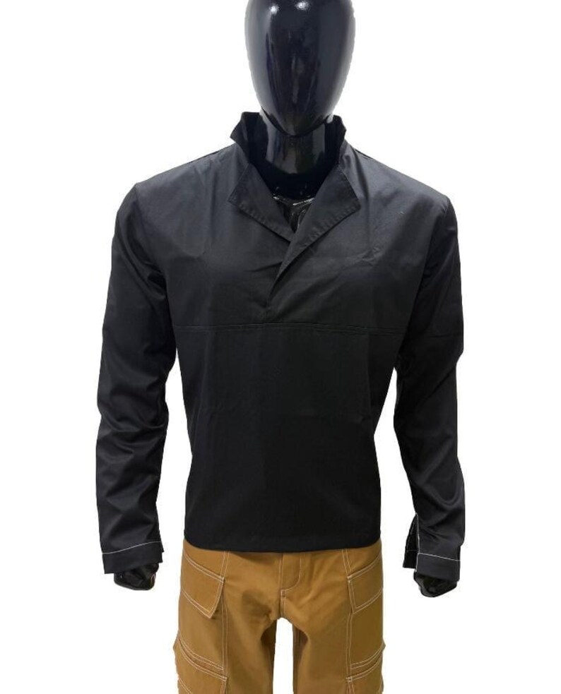May include: Black long-sleeved shirt with a collared neckline and a button-down design. The shirt is paired with tan cargo trousers. The outfit is displayed on a mannequin.