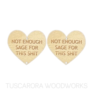 May include: Two wooden heart-shaped ornaments with the text "Not Enough Sage For This Shit" engraved on each.