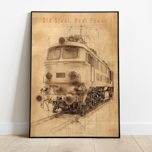 May include: Framed vintage-style print featuring a detailed illustration of a train on tracks. The artwork is in sepia tones with the text "Old Steel, Real Power" at the top. The print is displayed on a wooden floor.