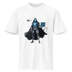 May include: White t-shirt with a futuristic illustration of a hooded figure holding a laptop. The figure is in silver armour with blue details and a black cape. The text "DEV²" is printed on the shirt.