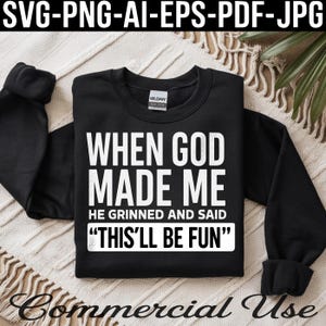 May include: Black sweatshirt with the text "WHEN GOD MADE ME HE GRINNED AND SAID 'THIS'LL BE FUN'" in white block letters. The sweatshirt is a Gildan Heavy Blend. The image also includes the text "SVG-PNG-AI-EPS-PDF-JPG" and "Commercial Use".