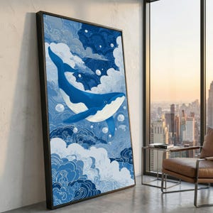 May include: A framed art print featuring a blue whale swimming in a stylized sky with clouds and bubbles. The whale is a vibrant blue with white accents, set against a backdrop of varying shades of blue. The artwork is in a black frame.