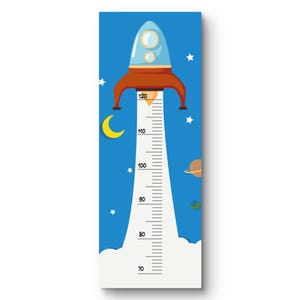 May include: A blue and white rocket ship-themed growth chart. The chart features a rocket ship at the top, a measurement scale, and illustrations of stars, a moon, and planets. The scale measures up to 120 inches.