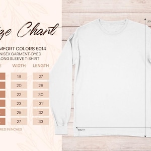 Op de afbeelding: Een wit t-shirt met lange mouwen naast een maattabel voor Comfort Colors 6014. De tabel toont de maten S tot 3XL met bijbehorende breedte- en lengtematen in inches, aangegeven met pijlen op de afbeelding van het t-shirt.