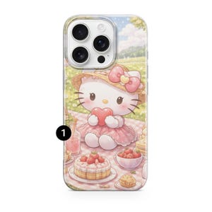 May include: A phone case with a Hello Kitty design. The cartoon character is wearing a pink dress and a straw hat, holding a heart. The case shows a picnic scene with cake, strawberries, and a drink. The case has a clear design with a white border.