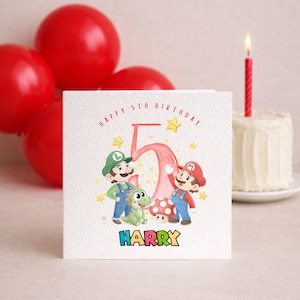 May include: A birthday card with the text "HAPPY 5TH BIRTHDAY" and the name "HARRY". The card features illustrations of Mario and Luigi characters, a green dinosaur, a mushroom, and star accents. Red balloons and a small cake with a lit candle are in the background.