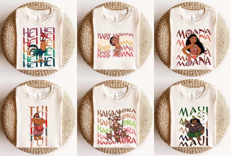 May include: Six off-white t-shirts with colorful graphics and text from the movie Moana. The designs include characters like Hei Hei, Baby Moana, Moana, Maui, and the Kakamora. Each shirt is displayed on a round, woven surface.