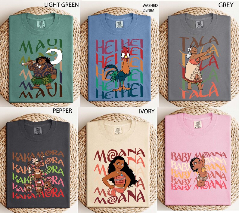 May include: Six t-shirts in various colors, each featuring a graphic from the animated film Moana. Designs include characters like Maui, Hei Hei, and Moana, with text overlays. Colors range from light green to pink.