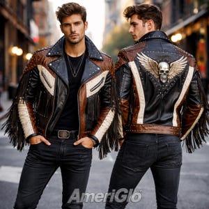 May include: A brown, black, and cream leather jacket with fringe and stud details. The back of the jacket features a silver skull with wings. The jacket is worn with black jeans and a black shirt. The jacket has a classic biker style.