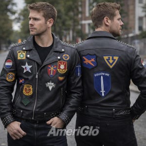 May include: Black leather jacket with multiple patches and silver studs on the shoulders and cuffs. The jacket features a zipper closure and a belt at the waist. The back of the jacket has a patch that says "FOLLOW ME".