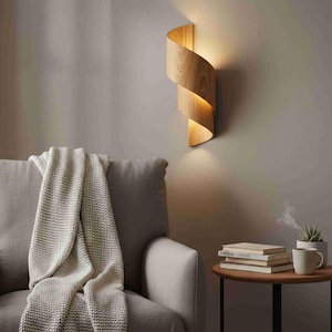 May include: A wooden wall sconce with a spiral design. The light fixture is made of light-colored wood and emits a warm glow. The sconce is mounted on a neutral-colored wall, creating a modern and minimalist aesthetic.
