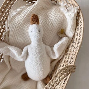 Patito de peluche de lana hecho a mano: un suave compañero para dormir para los más pequeños. Blanco