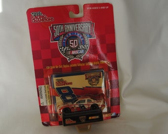May include: A red, white, and blue die-cast car model of the #8 car from the NASCAR Racing Champions series. The car is on a white card with the words "50th Anniversary" and "NASCAR" printed on it.