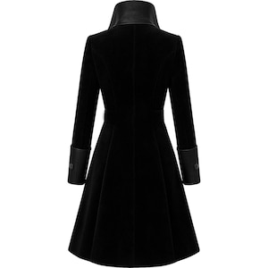 May include: A black coat with a high collar and long sleeves. The coat features a fitted waist with a belt and flared skirt. The collar and cuffs have a leather-like trim. The coat is a classic design, suitable for various occasions.
