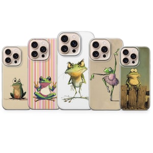 May include: Five smartphone cases featuring various frog illustrations. The designs include a sitting frog, a frog making peace signs on a striped background, an angry standing frog, a frog in a tutu, and a frog perched on a wooden fence.