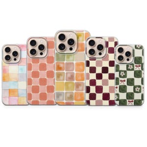 May include: Five smartphone cases arranged in a row, each featuring a distinct square grid pattern. The designs include watercolour pastels, solid peach, muted earth tones, deep burgundy and cream, and a dark green checkered print with bows.
