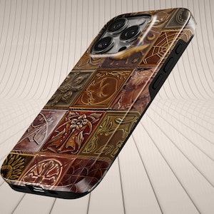 May include: A smartphone case featuring a grid of square panels in shades of brown, bronze, and gold. Each panel displays embossed imagery including floral motifs, celestial symbols, spider webs, and animal silhouettes, with a camera cutout.