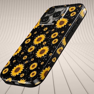 May include: Black phone case with a repeating pattern of yellow sunflowers with brown centres. The case has a glossy finish and a black border, with cutouts for the camera and buttons. Small white dots are included.