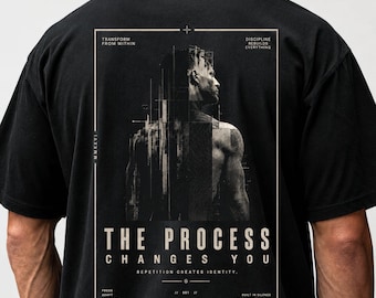 May include: Black t-shirt with a graphic on the back featuring a stylized image of a person and the text "THE PROCESS CHANGES YOU." Additional text includes "TRANSFORM FROM WITHIN" and "DISCIPLINE REBUILDS EVERYTHING."