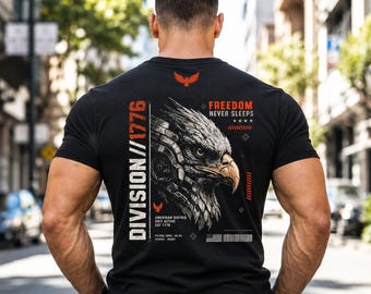 May include: Black t-shirt with a graphic of an eagle's head and the text "FREEDOM NEVER SLEEPS." The shirt also features the text "DIVISION // 1776" and "AMERICAN DISTRICT UNIT ACTIVE EST 1776."