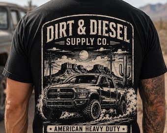 May include: Black t-shirt featuring a graphic of a truck kicking up dust in a desert landscape. The shirt has the text "DIRT & DIESEL SUPPLY CO." and "AMERICAN HEAVY DUTY EST. 1976 Built For Long Roads."