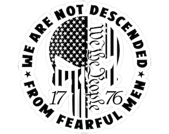 May include: A white sticker with a black graphic design. The design features a skull with the American flag on one side and vertical stripes on the other. Text includes "WE ARE NOT DESCENDED FROM FEARFUL MEN" and "We the People 1776".