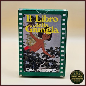 May include: A rectangular green game box featuring an illustration of Mowgli from The Jungle Book. The text reads Il Libro della Giungla, Walt Disney Productions, gioco di memoria, gioco dell'uomo nero, and the brand name DAL NEGRO in white.
