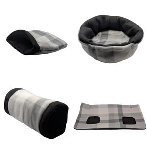 May include: A collection of pet beds and accessories in a gray and white plaid pattern with black accents. The set includes a round bed, a covered bed, a tunnel, and a flat mat with two openings. These items are designed for small pets.