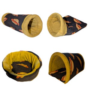 May include: A set of four pet beds and tunnels. The beds and tunnels are black with a pattern of hot dogs and buns. The interior is yellow. The beds and tunnels are designed for small pets.