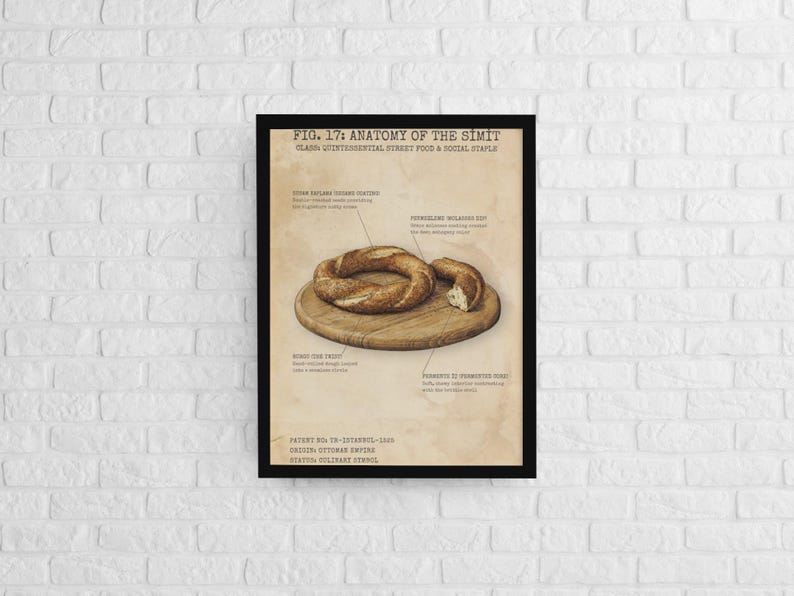 May include: A framed print titled "FIG. 17: ANATOMY OF THE SIMIT" on a white brick wall. The print depicts a detailed illustration of a simit, a Turkish sesame bread, with labeled anatomical parts. The simit rests on a wooden cutting board.