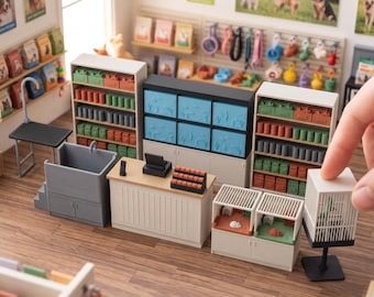 May include: A miniature pet store playset featuring shelves stocked with small boxes, a grooming station with a sink, a checkout counter, and animal enclosures. The text DIGITAL STL FILES - NO PHYSICAL ITEM and INSTANT DOWNLOAD is visible.