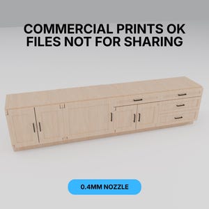 May include: A light-colored wooden cabinet with doors and drawers. The cabinet has black handles and is labeled with the text "COMMERCIAL PRINTS OK FILES NOT FOR SHARING" and "0.4MM NOZZLE".