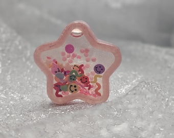 Star shaped, pink fluid shaker, quick sand phone grip or badge reel