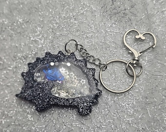 Hedgehog shaped, black silver glitter,  dry rattle shaker keychain with clip.