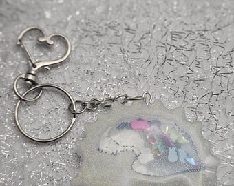 Hedgehog shaped, shimmering snow white,  dry rattle shaker keychain with heart clip.
