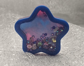 Star shaped, blue and pink dry rattle shaker, phone grip or badge reel