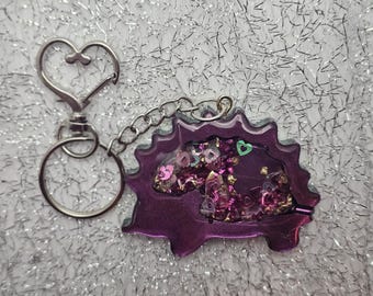 Hedgehog shaped, pink green gold color, dry rattle shaker keychain with heart clip.