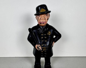 Hucha de hierro fundido con la imagen de un policía Mulligan.