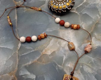 Colar de couro estilo boho com pingente de cerâmica, pedra de jaspe e contas decorativas de madeira.