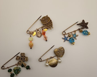 Broche de alfinete de segurança em latão antigo, adornado com pingente.