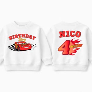 May include: White sweatshirt featuring Lightning McQueen from the movie Cars. The front displays "BIRTHDAY Boy" with the car graphic. The back has "NICO" above a large "4" with flames and "95".