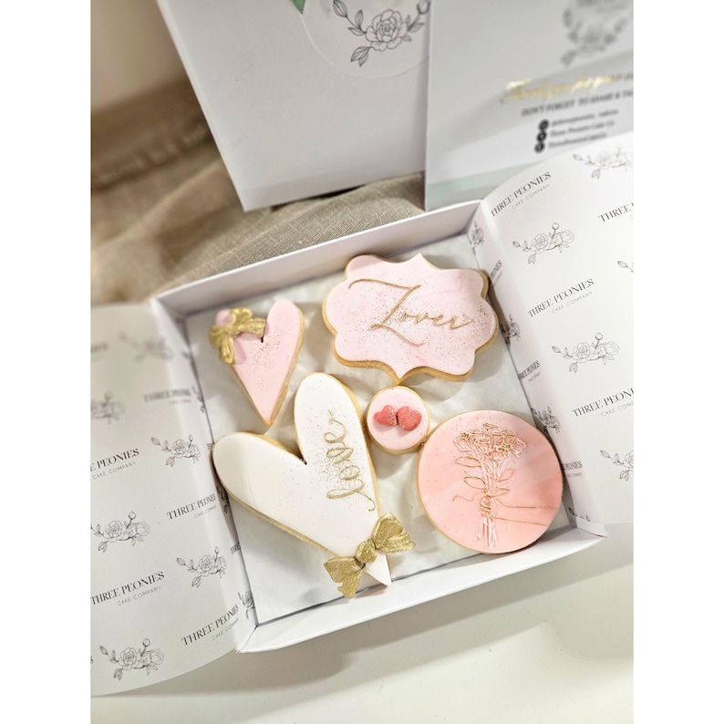 May include: A set of three ceramic mugs with a speckled, matte finish in cream, light grey, and dark grey. Each mug has a simple, minimalist design and a rounded handle.