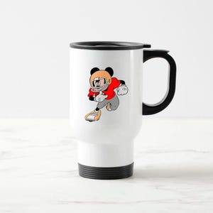 May include: White travel mug with a black handle and rim. The mug features a cartoon illustration of a character in a football uniform, running with the ball. The character is wearing a red jersey, gray pants, and an orange helmet.