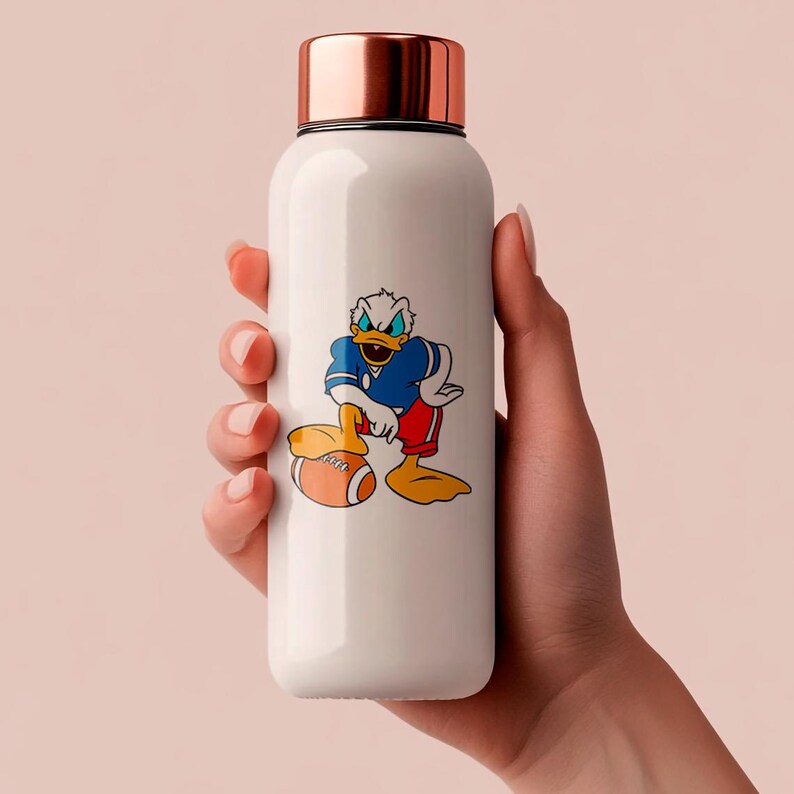 May include: White insulated water bottle with a copper-colored lid. The bottle features a cartoon image of Donald Duck in a football uniform, holding a football. The bottle is cylindrical and appears to be made of stainless steel.