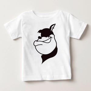 May include: White toddler t-shirt featuring a black and white cartoon graphic of a smiling dog's face. The graphic is a simple, bold design. The shirt has short sleeves and a crew neck.