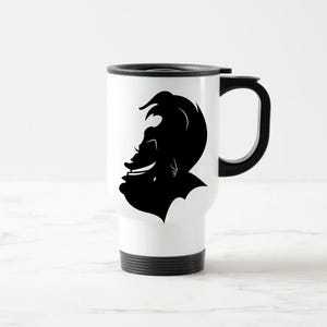 May include: White travel mug with a black silhouette of a person's profile. The mug has a black handle, a black lid, and a black base. The profile is a stylized image of a person with a distinctive hairstyle and facial features.