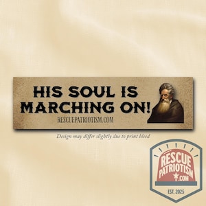 May include: A rectangular sticker with the text "HIS SOUL IS MARCHING ON!" in bold black letters. The sticker features an illustration of a man with a long white beard and the website RESCUEPATRIOTISM.COM.